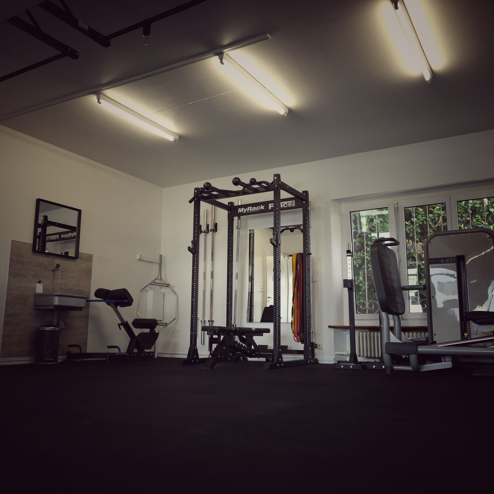 Bright training room with squat rack